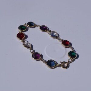 Women`s gold tone multi color disk bracelet. 7in.